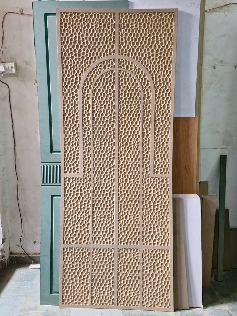 3D CNC door with an arched centre panel inside a perforated MDF jaali field