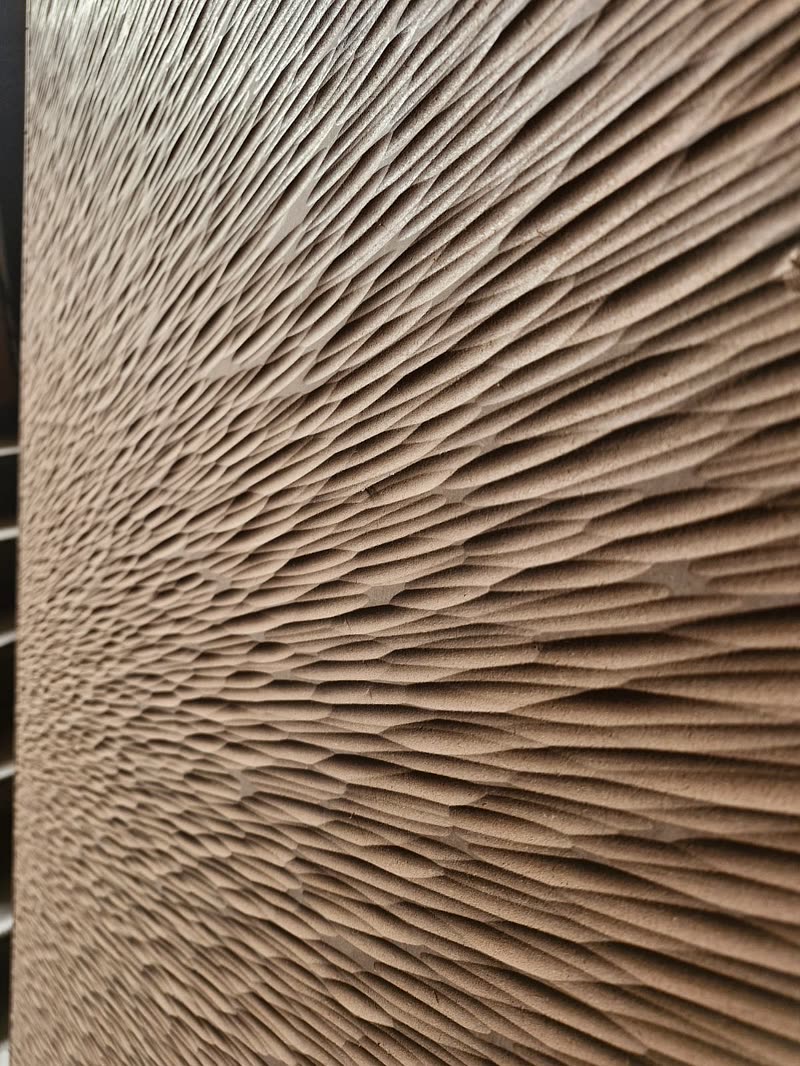 Close up of a 3D wall panel with a chisel-look texture cut across the face by CNC router