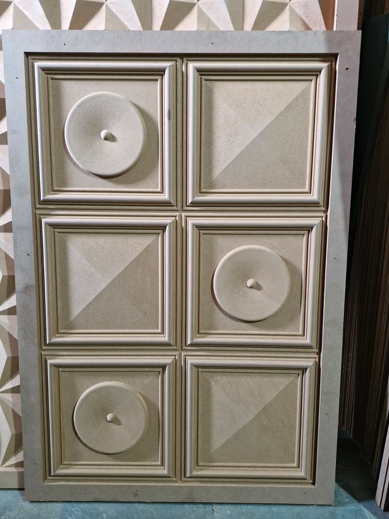 CNC ceiling and wall panel with coffered squares and turned discs cut into raw MDF