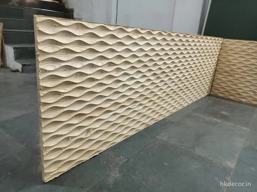 CNC cut diamond tessellation wall panel with faceted pyramids running along a wall