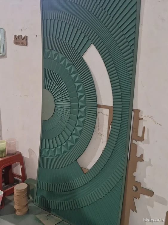 CNC carved mandala door panel with radial carving, primed and standing in the workshop