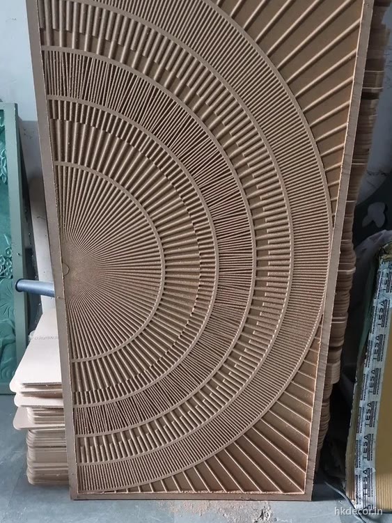 CNC carved radial fan door panel in raw board straight off the router bed