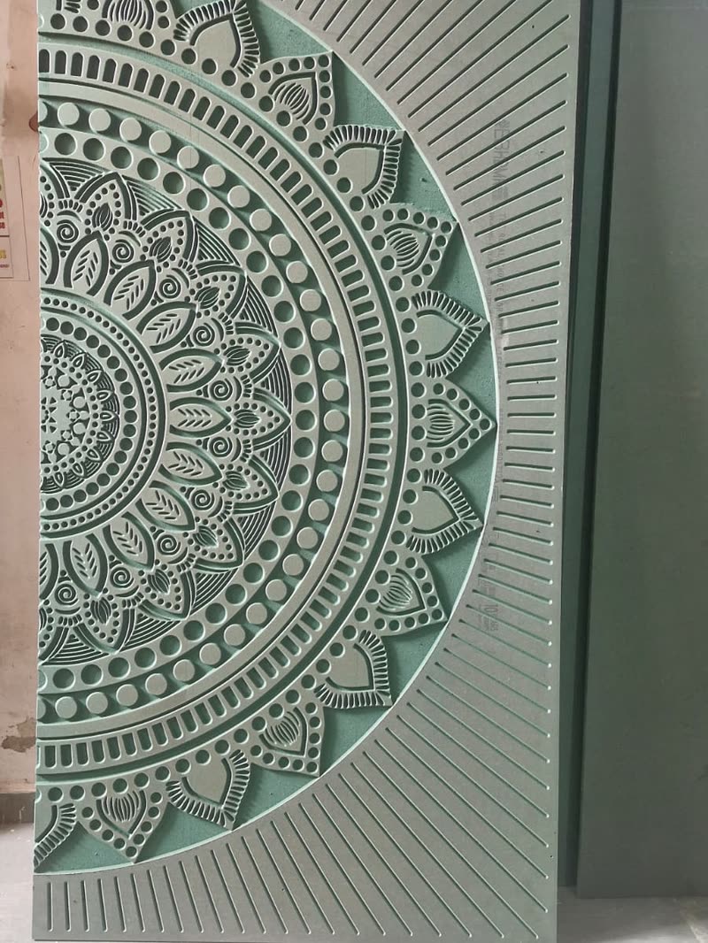 Half mandala CNC carved panel with a radial fan running off the edge of the board