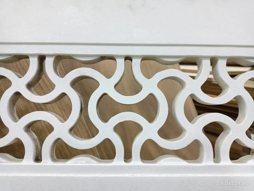 CNC cut jaali screen with a repeating arch pattern finished in white