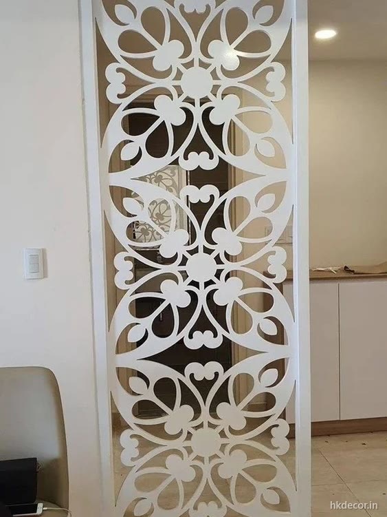 Full height CNC cut jaali room divider separating two rooms while letting light through