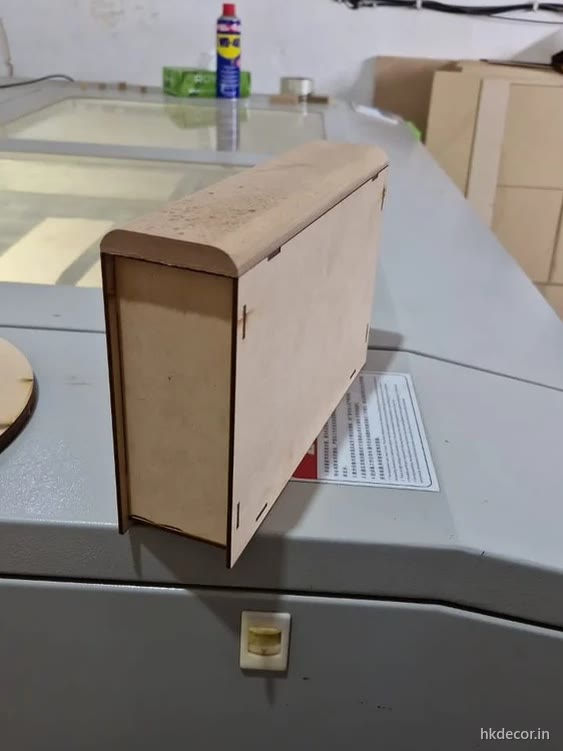 Laser cut flat-pack box in thin board with cut corner joints, raw