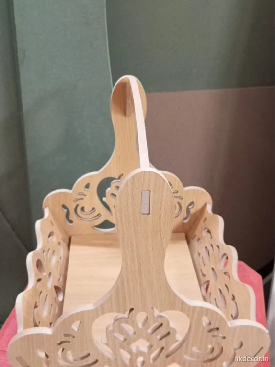 Laser cut jhula swing with a perforated motif in the back panel, natural board