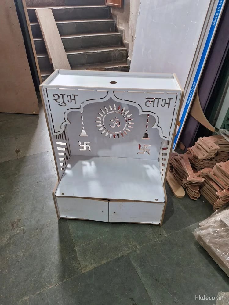 Laser cut home mandir finished in white with cut lettering across the top