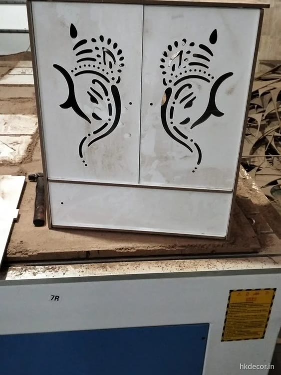 CO2 laser cutting a fine perforated motif through thin board at the Dream3 workshop