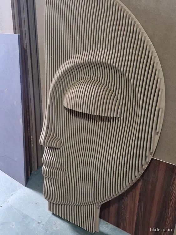 Parametric wall panel with a face profile emerging from stacked CNC cut ribs in raw board