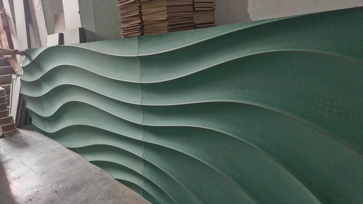 Close up of a CNC cut 3D wave wall panel showing the pitch and flow of the carved surface in MDF