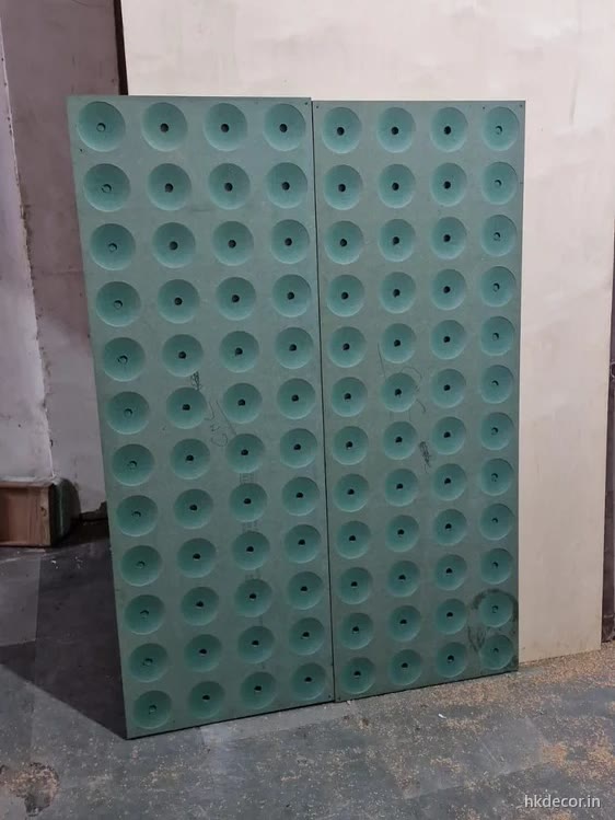 CNC cut wall panel with an even field of round perforations, primed board