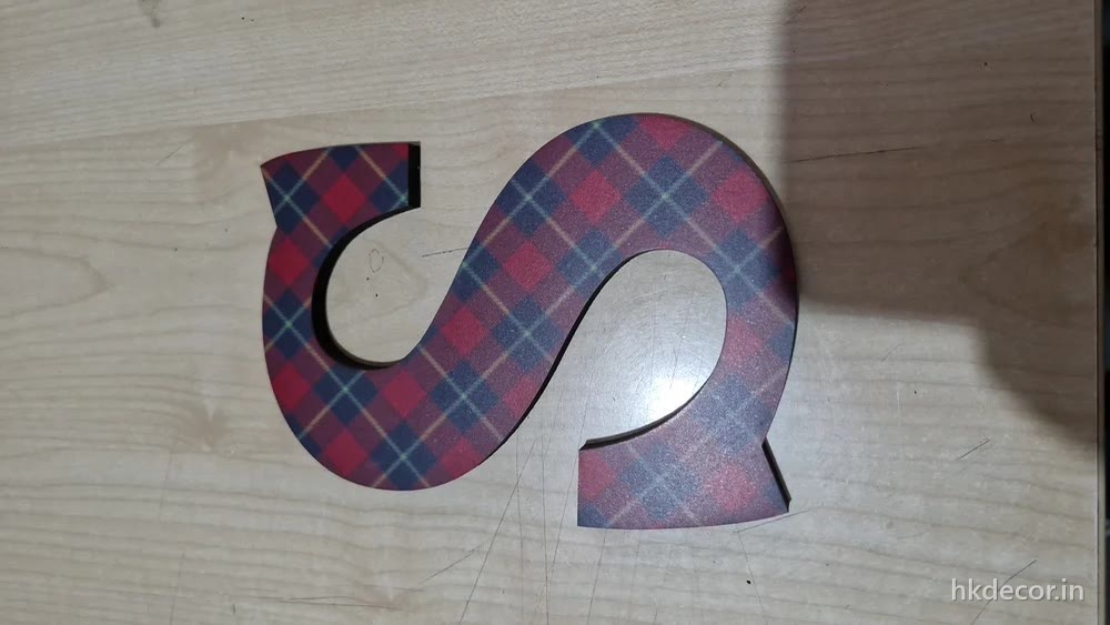 Single CNC cut signage letter finished in a patterned laminate