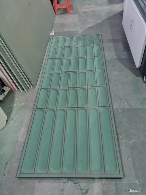 CNC cut wall panel with a grid of rounded slot cut-outs, primed and ready for finishing