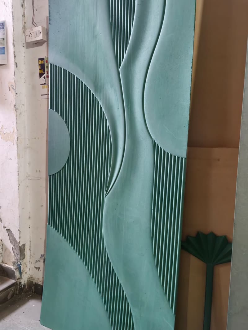 Fluted wall panel with a carved parametric wave running across vertical flutes, CNC cut MDF