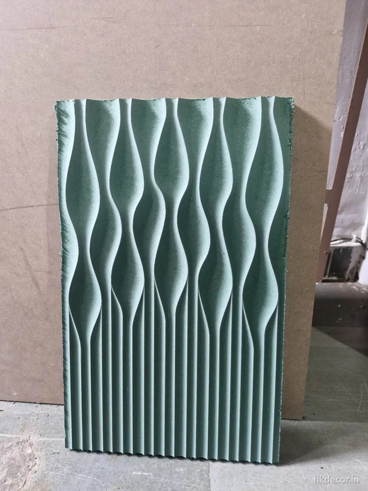 CNC cut 3D wall panel with a tapering vertical wave cut edge to edge in primed board