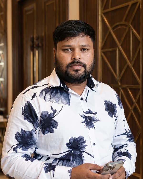 Satish Kumar, operations head at Dream3, standing in front of a carved CNC door panel